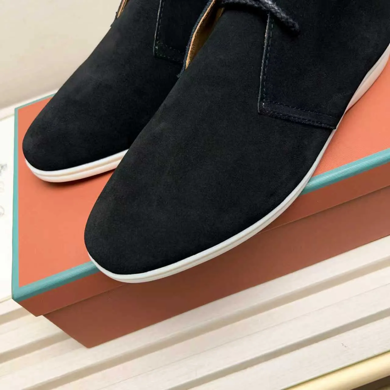 Men's Shoes 💰420 Loro Piana reimagines the desert boot—a modern, comfortable interpretation of a classic 1940s style. Crafted from suede calfskin, it exudes elegance. The tight texture of suede calfskin is not only durable but also looks casual and sophisticated. Add a timeless piece to your shoe collection, harmoniously blending comfort, style and Loro Piana's heritage of craftsmanship. Acetate satin detail on the inside White sole with LP lettering for added traction Space for a personalized signature on the heel Tonal suede trim Upper: 100% cow split suede Sole: 100% Rubber lining: Cow leather